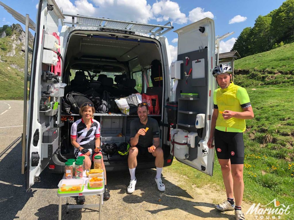 Cyclists having a snack from Marmot Tours support van on fully supported European road cycling holiday with Marmot Tours