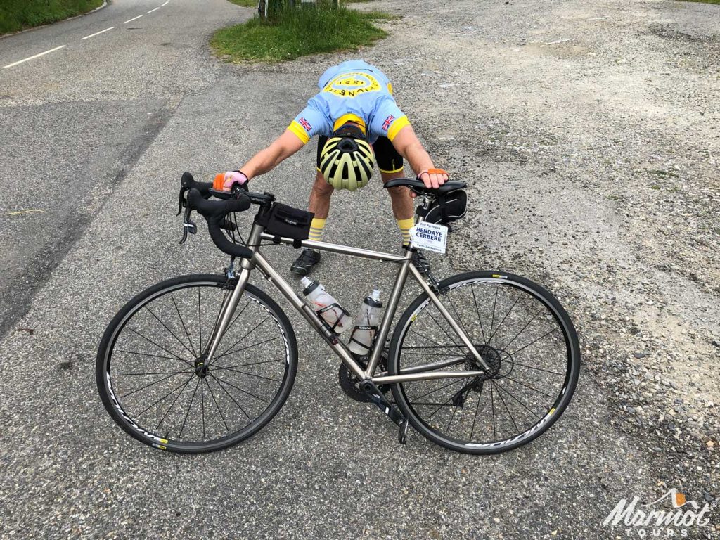 Cyclist stretching Raid Pyrenean cycling challenge Marmot Tours