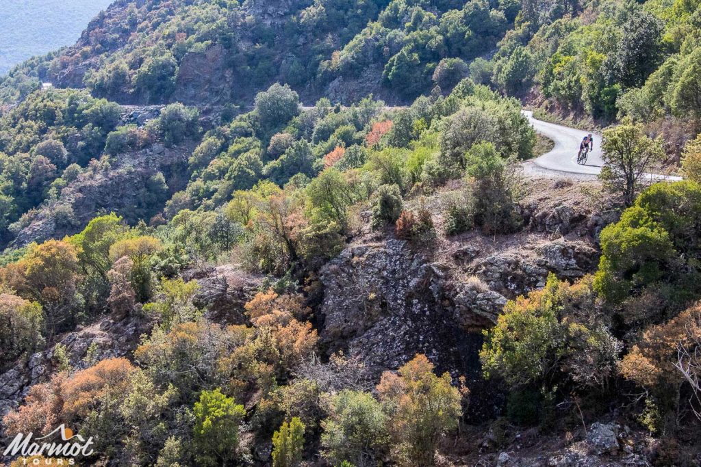 Cyclist heading towards St Florent from Ponte Lecchia on the Classic Cols of Corsica road cycling holiday with Marmot Tours