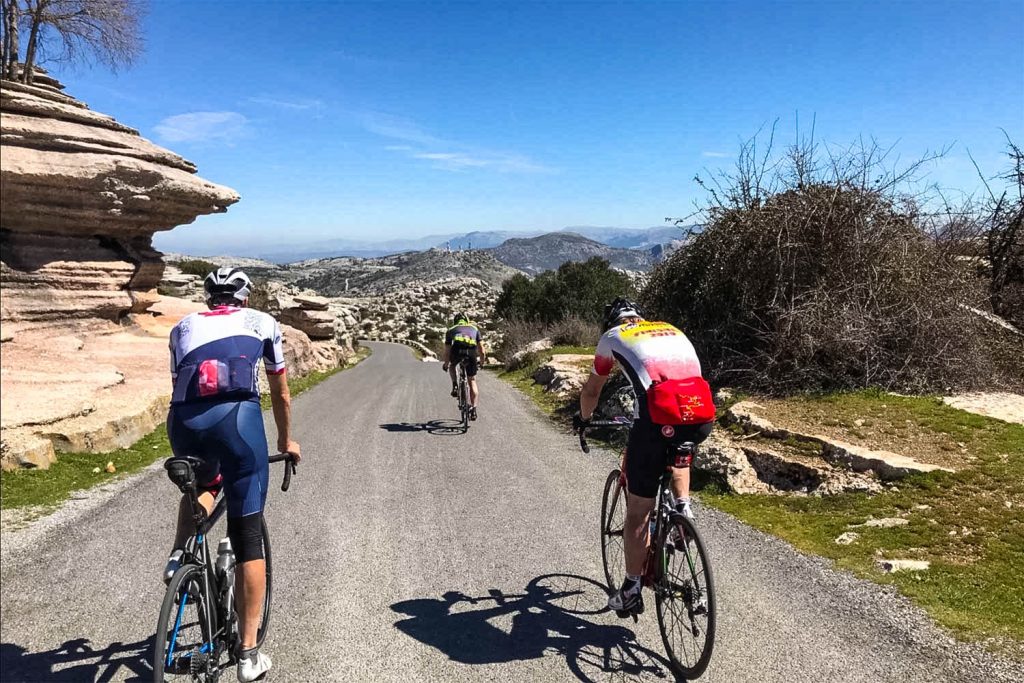 Trio of cyclists on hillside descent on Marmot Tours road cycling holidays Spain Andalusia