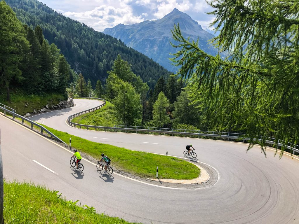 Three cyclists on hairpin bend in Italian Dolomites on Marmot Tours road cycling holiday