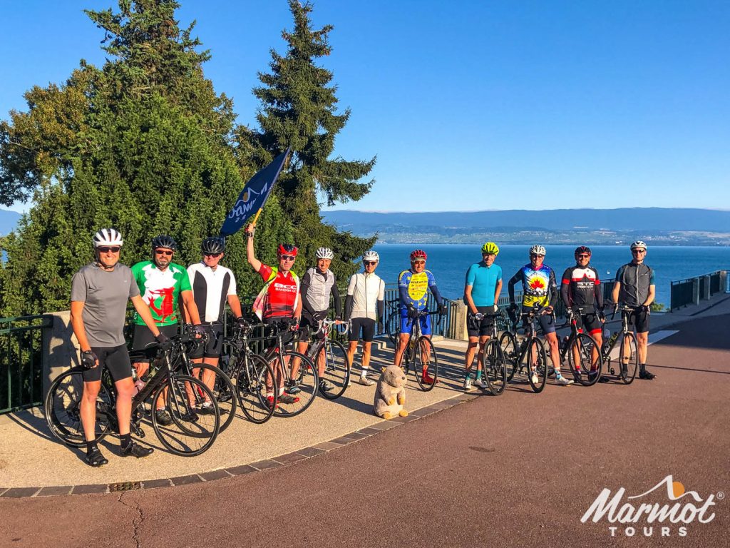 Group of cyclists posing with bikes on Marmot Tours Raid Alpine cycling challenge