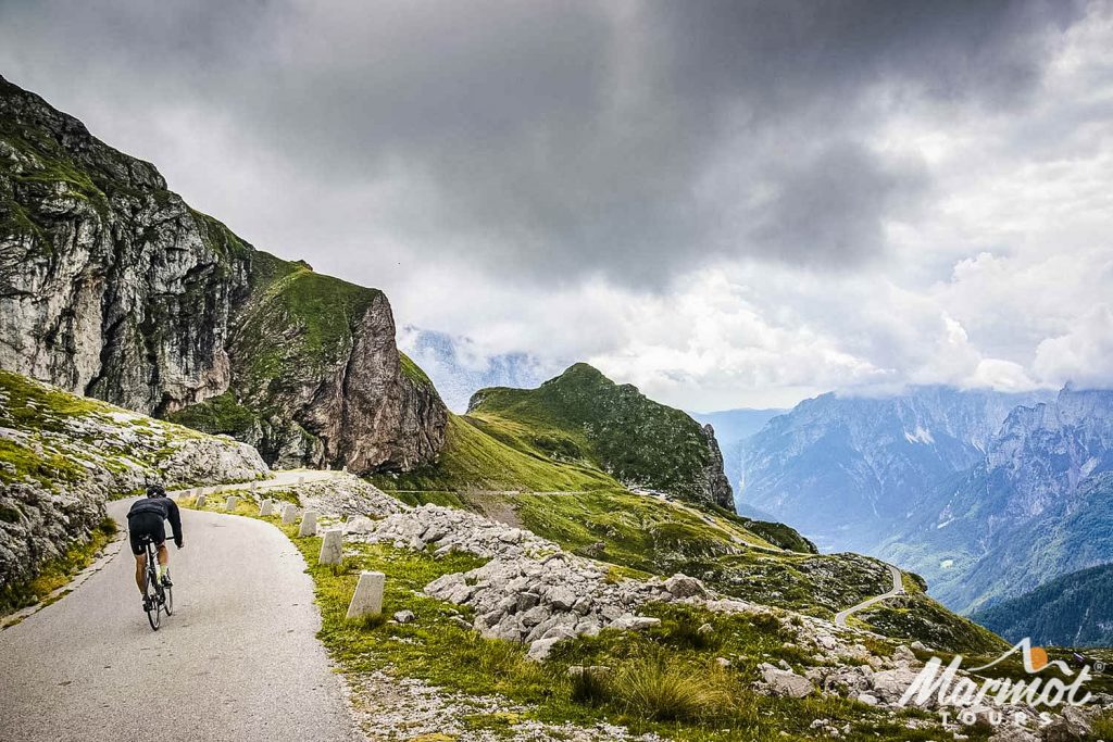 Cyclist on high section of Mangart pass on Marmot Tours fully supported road cycling holiday of Slovenia