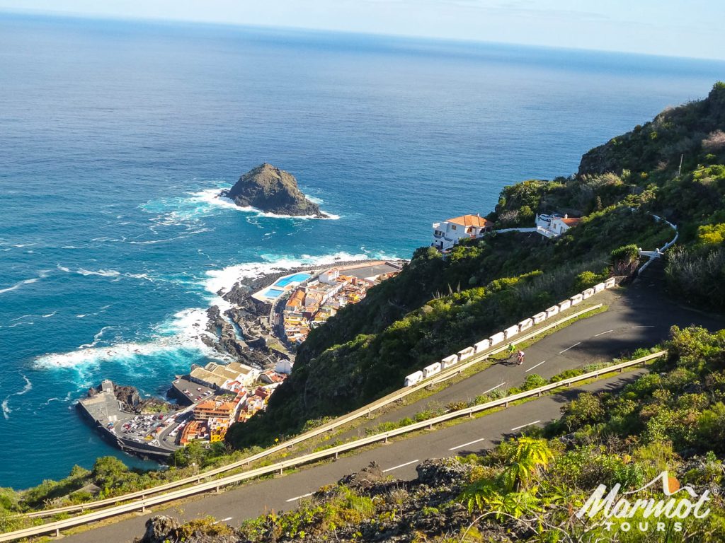 Cyclists on hairpin bend above sea on Marmot Tours guided road cycling tour of Tenerife