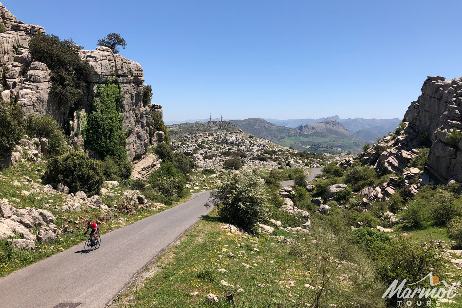 Cyclist climbing in El Torcal Andalusia on Marmot Tours road cycling holiday Andalusia