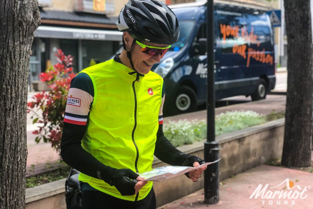 Cyclist reading route notes on Marmot Tours road cycling holiday Spain Catalonia and Girona