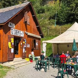 Group of cyclists enjoying crepes at Col de Peyresourde cafe on Marmot Tours fully supported guided Raid Pyrenees