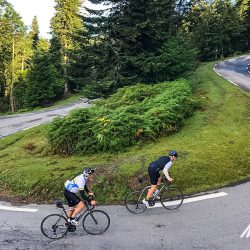 Pair of cyclist climbing hairpin bend on day 3 of Raid Pyrenees cycling challenge with Marmot Tours