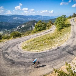 Cyclist rounding hairpin bend on foothills of Mont Ventoux with Marmot Tours