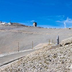 Cyclist pausing to pay respect near Tom Simpson memorial Mont Ventoux with Marmot Tours full support cycling holiday