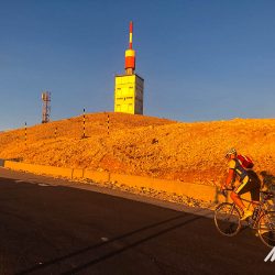 Cyclist sunrise approaching summit of Mont Ventoux with Marmot Tours guided road cycling holidays