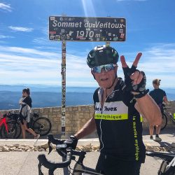 Cyclist celebrating 2nd ascent of Mont Ventoux on guided cycling challenge Mont Ventoux with Marmot Tours