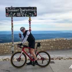 Cyclist celebrating 3rd ascent of Mont Ventoux on guided cycling challenge Mont Ventoux with Marmot Tours