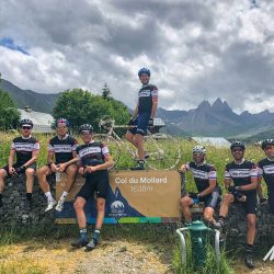 Group of cyclists pose at Col du Mollard on Marmot Tours guided cycling tour of French Alps