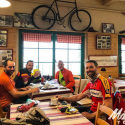 Cyclists enjoying cafe break on guided road cycling holiday in Pyrenees with Marmot Tours