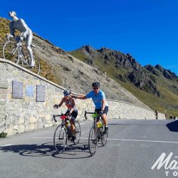 Couple summiting col du Tourmalet on Marmot Tours guided road cycling holiday pyrenees France