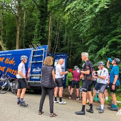 Cyclists and Marmot Tours guide gather round support van on Raid Pyrenean cycling challenge