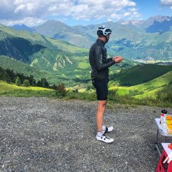 Cyclist looking down valley while enjoying support from Marmot Tours support van on guided Pyrenean cycling holiday
