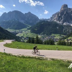 Cyclist riding on valley floor on Marmot Tours full support cycling holiday in Dolomites Italy