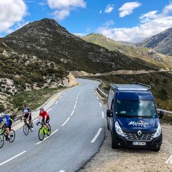 Group of cyclists and Marmot Tours support vehicle on guided cycling holiday of Corsica
