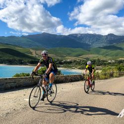 Pair of cyclists on coast road on Marmot Tours guided cycling holiday in Corsica