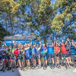 Group of cyclists and Marmot Tours support vehicles on guided cycling tour of Corsica