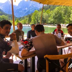 Group of cyclists eating lunch in restaurant Lake Bled on Slovenia road cycling holiday Marmot Tours