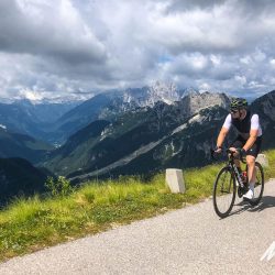 Cyclist climbing Saddle of Mangart on Slovenia supported cycling holiday with Marmot Tours