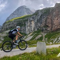 Cyclist enjoying climbing Mangart Saddle Triglav National Park with Marmot Tours road cycling holiday Slovenia
