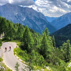 Two cyclists climbing Mangart Saddle on Slovenia guided cycling holiday with Marmot Tours