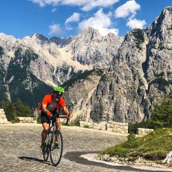 Cyclist enjoying cobbles of Vrsic pass on guided road cycling holiday Slovenia with Marmot Tours road cycling holidays
