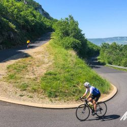 Cyclist climbing hairpin bend on guided road cycling tour South of France Marmot Tours