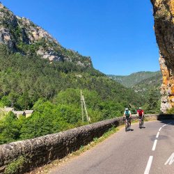 Cyclists enjoying balcony road through gorge on guided cycling tour of south of France with Marmot Tours