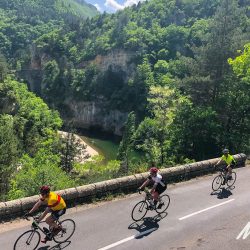 Group of cyclist passing over river in Cevennes and Ardeche South of France cycling holiday Marmot Tours