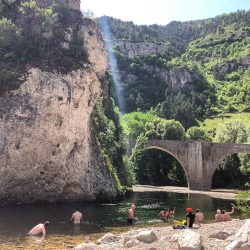 Cyclists cooling off in the river on guided cycling holiday I South of France Cevennes & Ardeche with Marmot Tours