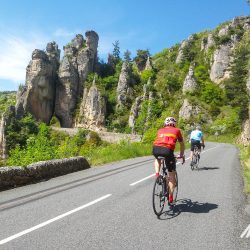 Cyclists enjoying rocky climb on guided road cycling tour of south of France Cevennes & Ardeche with Marmot Tours