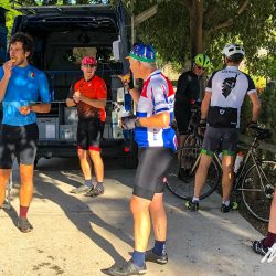 Group of cyclists enjoying snacks and support from van on Marmot Tours guided cycling tour of Andalusia Spain