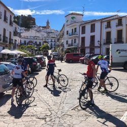 Cyclist in town square on Marmot Tours guided group cycling holiday Andalusia Spain