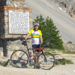 Cyclist posing for a photo at Col d'Izoard French Alps on Marmot Tours Raid Alpine cycling challenge