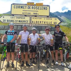 Group of cyclists posing for photo on Cormet de Roselend on Marmot Tours Raid Alpine cycling challenge