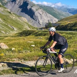 Female cyclist enjoying a climbon Marmot Tours Raid Alpine cycling challenge French Alps