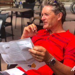 Cyclist in cafe reading route notes on Marmot Tours fully supported guided cycling tour of Girona Catalonia Spain