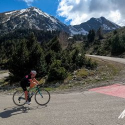Cyclist climbing hairpin bend on Vallter 2000 Vuelta d'Espana climb with Marmot Tours fully supported guided road cycling holiday Girona cycling tour Catalonia Spain