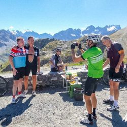 Group of cyclists posing for pictures on Col du Gaiiery on Marmot Tours guided cycling mini break of French Alps