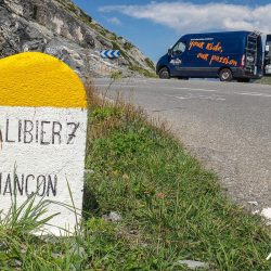 Marmot Tours support vehicle and Col du Galibier kilometre road marker on guided cycling tour of the Alps