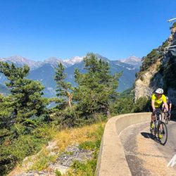 Group of cyclists enjoying dramatic scenery of the Alps on Marmot Tours guided road cycling short break