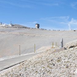 Cyclist ;pausing to pay respects at Tom Simpson memorial on Mont Ventoux on Marmot Tours guided road cycling holiday Provence France