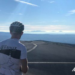 Cyclist admiring view from summit of Mont Ventoux on Marmot Tours guided road cycling tour Provence France