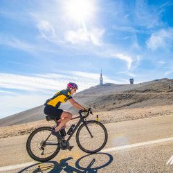 Female cyclist climbing Mont Ventoux with beacon in background on Marmot Tours full support road cycling tour Mont Ventoux