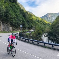 Female cyclist cycling in gorge in Picos de Europa Northern Spain guided road cycling tour with Marmot Tours